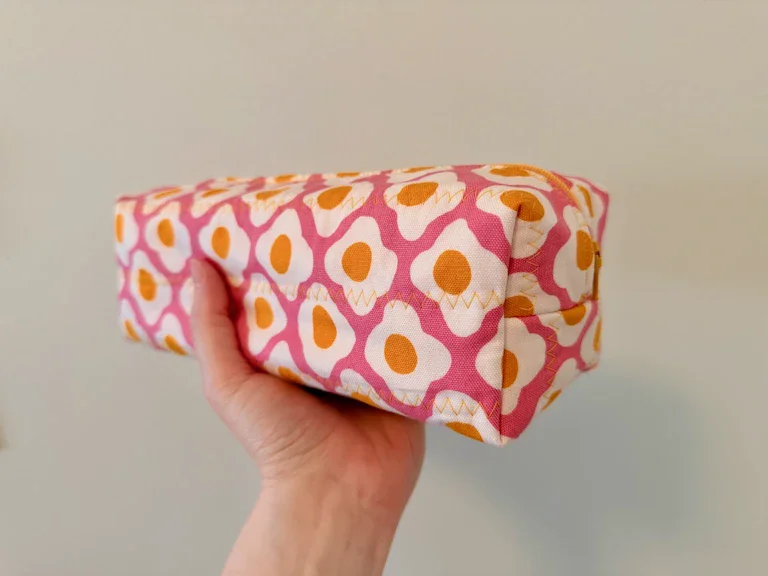 My hand holding the egg pouch at a handle