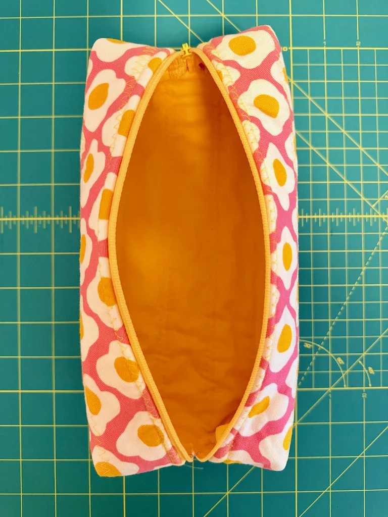 The egg pouch open to reveal a coordinating yellow fabric lining