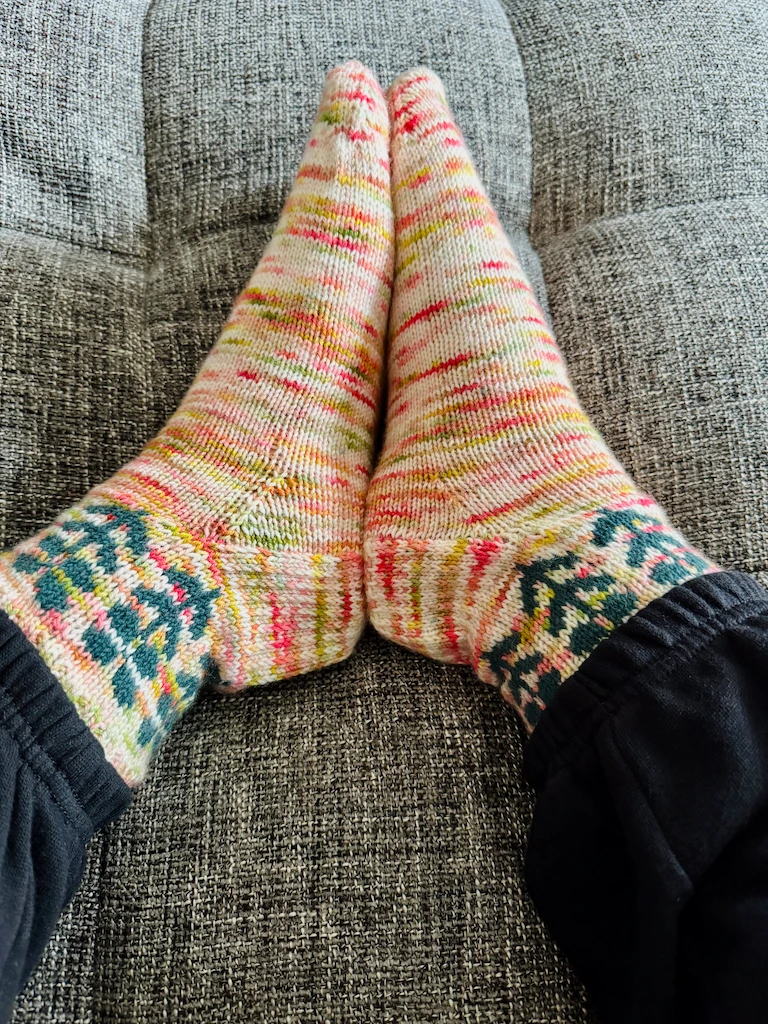 Me wearing the socks on my feet, with the soles of my feet pressed together. The socks fit perfectly, if I do say so myself.