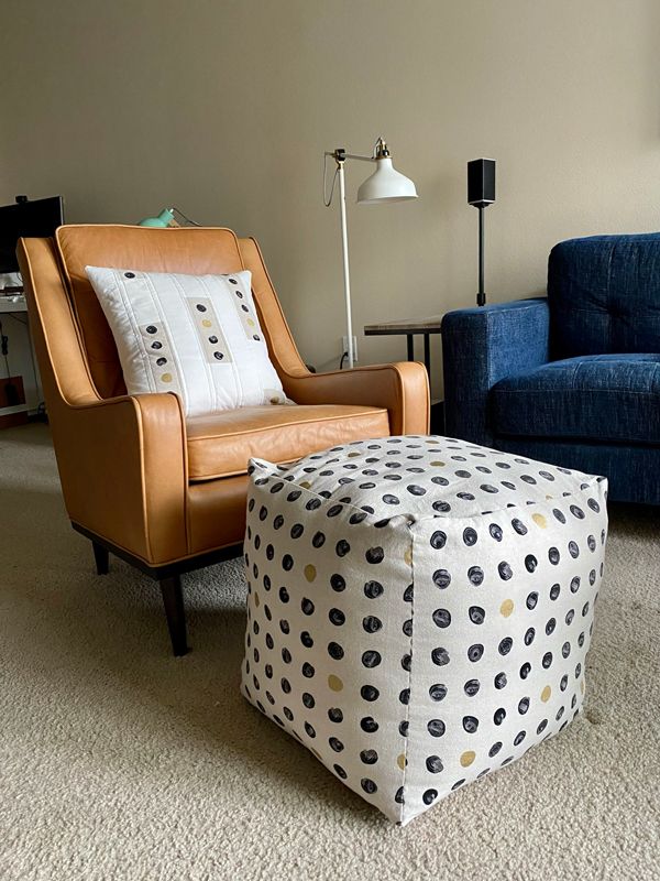 Another view of the living room, taken from closer to the floor so that the pouf looms larger