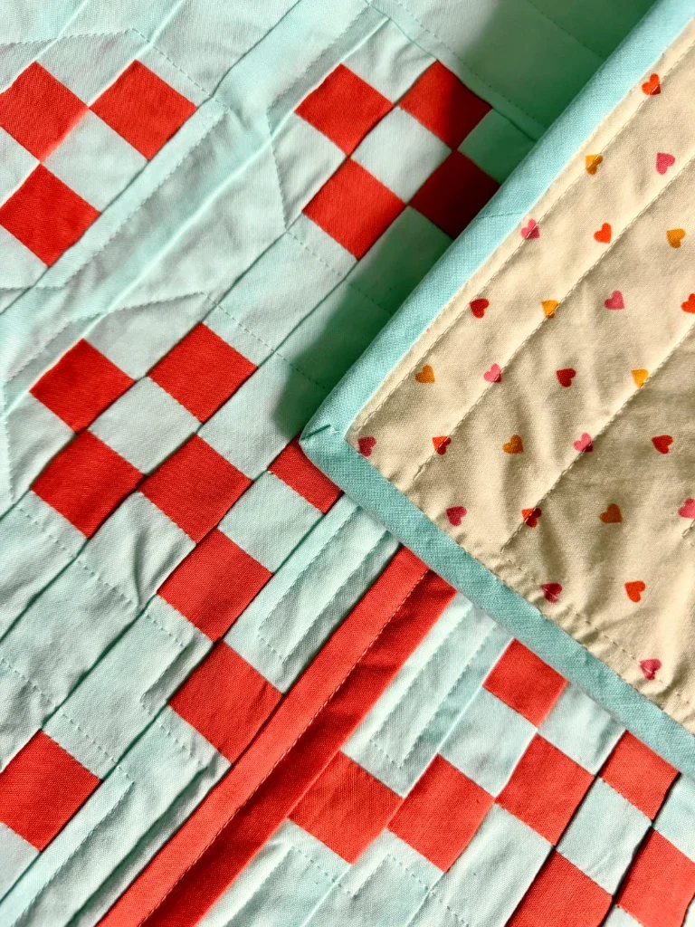 Another view of the corner flipped over to show the backing fabric, this time on a jaunty angle