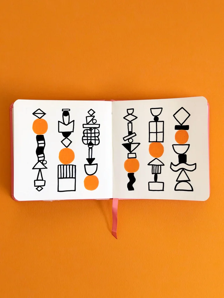Six columns of geometric cairns: stacked shapes in black acrylic marker. In each stack is an orange ball, and it’s positioned in each column to look like it is bouncing across the spread