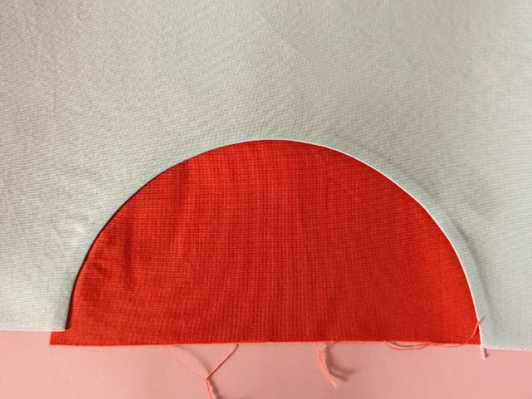 The work in progress, showing the half circle successfully sewn to the background fabric