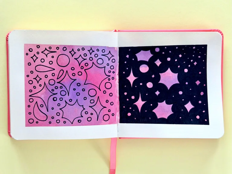 Clouds of pink and purple ink blend into each across a sketchbook spread. On the left there are black outlines of stars and comets in black acrylic marker. On the right, the stars are formed by negative space: they are pink and purple in a field of black acrylic marker.