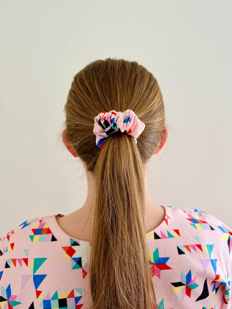 The back of my head so that you can see a matching pink scrunchie holding my ponytail. The back collar of the shirt looks pretty good too, not gonna lie!