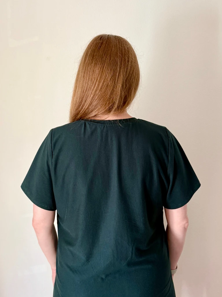 The back of the dress, featuring very subtle pooling of the fabric around the back of the neckline.