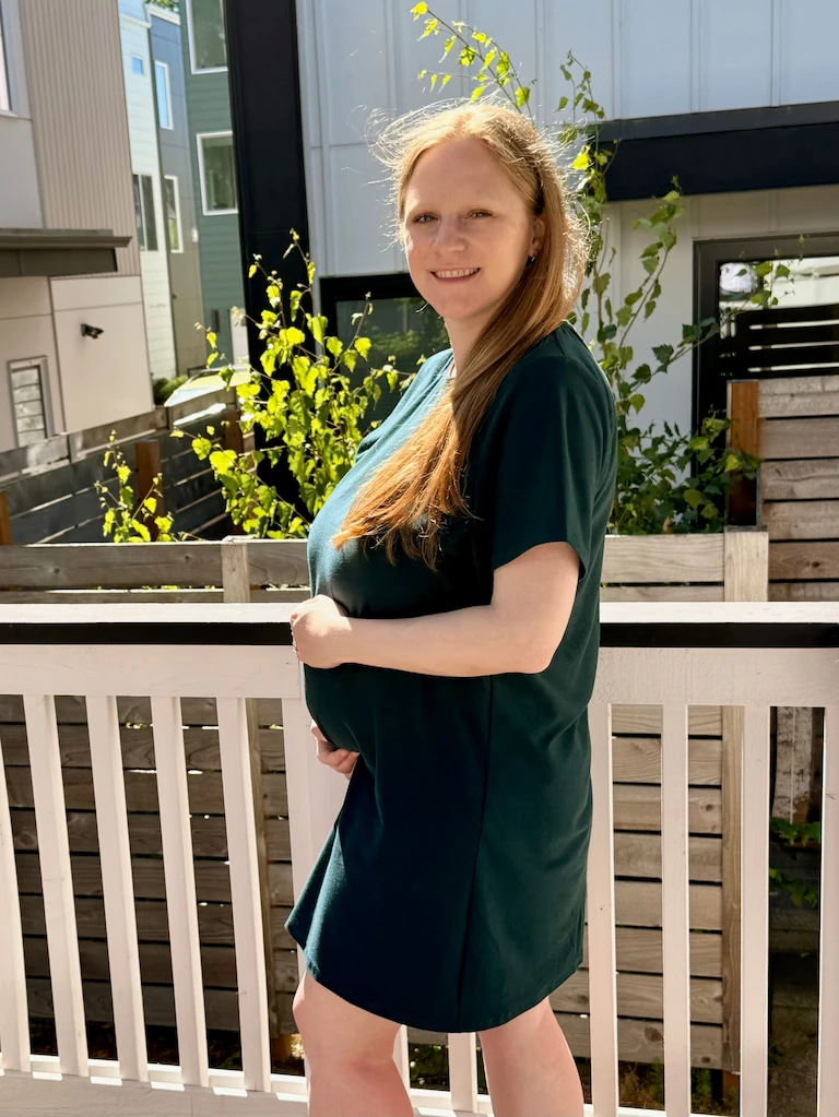 Me facing sideways and showing off my bump! It's not too significant now, you probaby won't notice in this dress based on how it drapes.